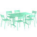 A Lancaster Table & Seating seafoam powder-coated aluminum table with green chairs.