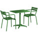 A green Lancaster Table & Seating outdoor table with two green chairs.