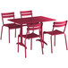 A Lancaster Table & Seating sangria powder-coated aluminum outdoor table with chairs set up on an outdoor patio.