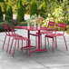 A Lancaster Table & Seating sangria outdoor dining set with a table and four chairs on a patio.