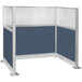 A blue cubicle partition with silver trim and a window.