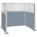 A Versare Hush Panel U-shape cubicle with a blue and white panel and a window.