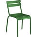 A green metal chair with a backrest.