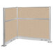 A Versare beige L-shaped cubicle with metal frame and electric channel.