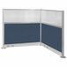A white metal L-shaped cubicle with blue and white Versare panels.
