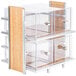 A clear glass and wood two tier bread display case.