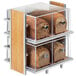 A Cal-Mil two tier bread display case with clear containers of bread.