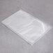 An ARY VacMaster clear plastic vacuum packaging bag on a grey surface.