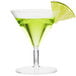 A Fineline clear plastic martini glass filled with green liquid and a slice of lime.