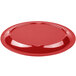 A Carlisle red melamine oval platter on a table.
