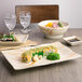 A rectangular melamine plate with sushi on a table.