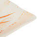 A white rectangular melamine plate with orange orchid designs.