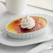 A White Toque Creme Brulee dessert on a plate.