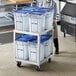 A man standing next to a cart with blue Vigor ice totes.