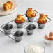 A Baker's Mark carbon steel popover pan with six muffins in it.