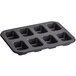 A black carbon steel bread pan with 8 mini loaf compartments.