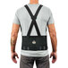 A back view of a man wearing a black Ergodyne ProFlex 1625 back support brace with elastic straps.