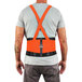 A person wearing an Ergodyne ProFlex Hi-Vis back support brace with a safety vest.