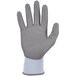 A close-up of a medium-sized Ergodyne ProFlex warehouse glove with a white and blue design.