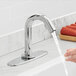 A person washing their hands under a Waterloo hands-free sensor faucet.