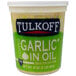 A case of Tulkoff chopped garlic in oil on a deli counter.