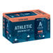 A blue box of Athletic Brewing Co. All Out Non-Alcoholic Extra Dark beer cans with orange accents.