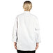 A woman wearing a white Uncommon Chef executive chef coat.