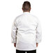 A man wearing a Uncommon Chef white long sleeve chef coat.