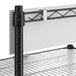 A black and silver metal shelf with white shelf mats.