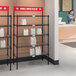 A Regency NSF take-out shelving station with white bags on it, and a red label on a white bag.