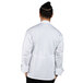 A man in a Uncommon Chef white long sleeve chef coat with mesh back.