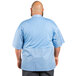 A man wearing a sky blue short sleeve chef coat with a mesh back.