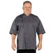 A man wearing a slate gray Uncommon Chef Venture Pro chef coat.