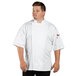 A man wearing a white Uncommon Chef Venture Pro chef coat.