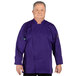 A man wearing a purple Uncommon Chef long sleeve chef coat with mesh back.