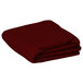 A folded burgundy rectangular table cover on a white background.