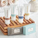 A group of white and blue Tommy Bahama shampoo bottles on a wooden shelf.
