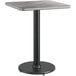 A Lancaster Table & Seating grey and white laminated table top on a table with a black base.