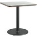 A Lancaster Table & Seating square table with a white birch top and black base.