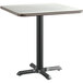 A Lancaster Table & Seating square table with a white surface and black base.