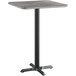 A Lancaster Table & Seating square bar table with a white and gray reversible top on a black metal base.
