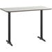 A white rectangular Lancaster Table & Seating bar table top with black edges on a black table base.
