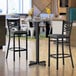 A close-up of a Lancaster Table & Seating reversible bar table and base.