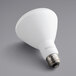 A close-up of a TCP Elite 10.5W dimmable LED light bulb with a white base and white surface.