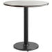 A round white table top with a black edge on a black base.
