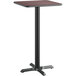A Lancaster Table & Seating reversible cherry and black laminated bar height table top with a black base.