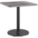 A square table with a black Lancaster Table & Seating base and reversible gray and white top.