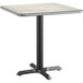 A Lancaster Table & Seating square table with a white and gray reversible surface on a metal base.