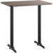 A Lancaster Table & Seating bar height table with a white birch top and black base.