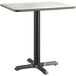 A Lancaster Table & Seating square table with a white top and black base.